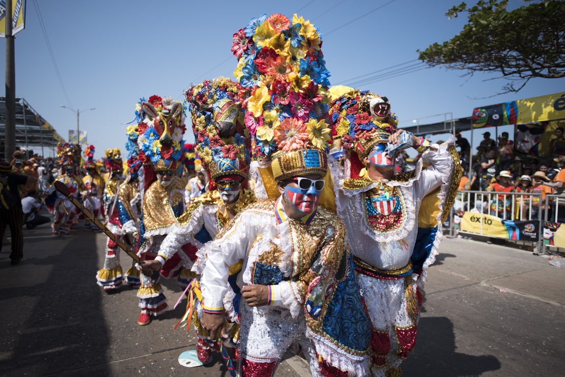 A group showing off for the crowd their costumes during the Batalla de Flores. RewritingtheMap/Emanuel Echeverri